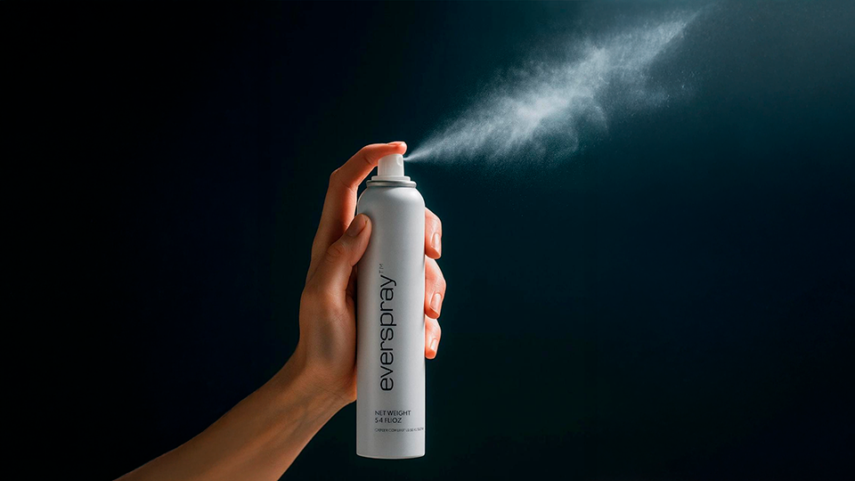 Hand spraying an aerosol powered by Everspray Tech